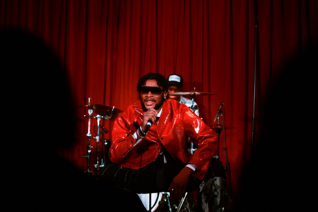 Ossy Brown performing live, seated
