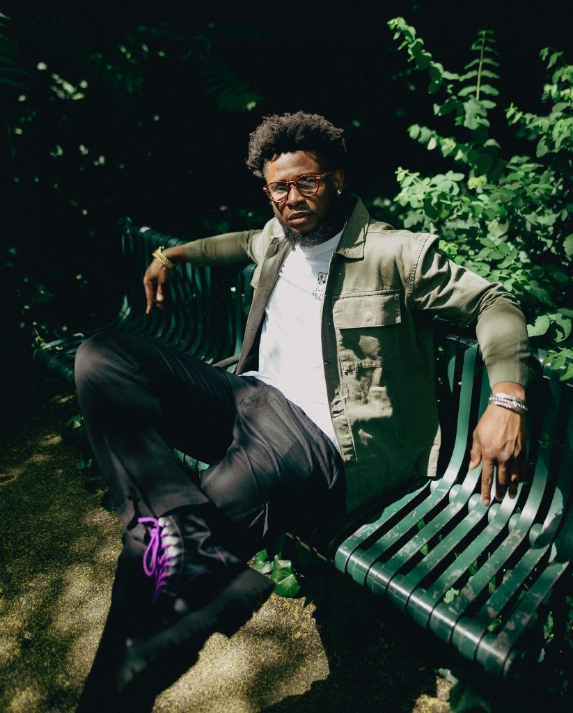 Ossy Brown seated on a park bench in London